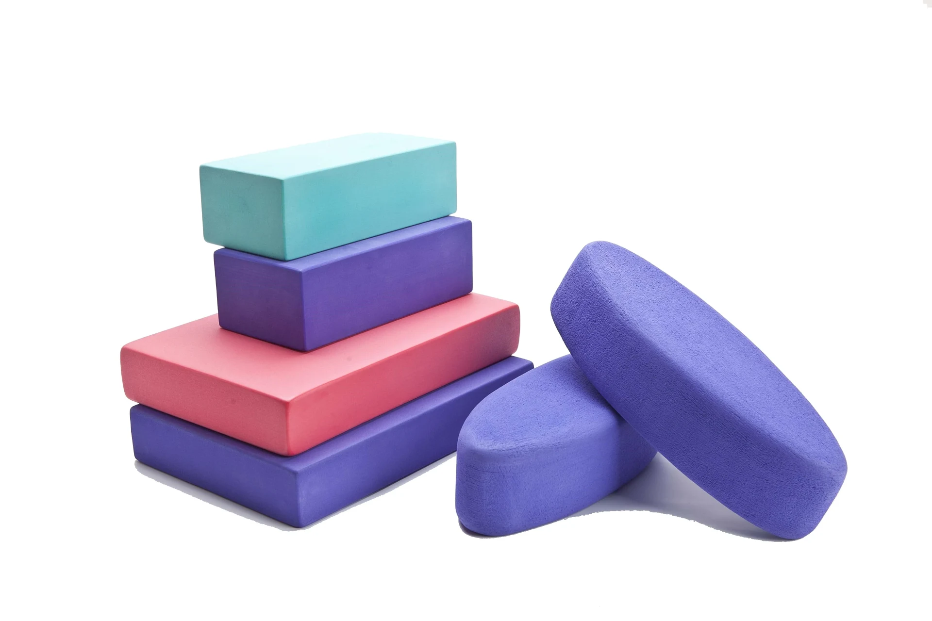 Stack of multicolored EVA yoga blocks ready for bulk shipment.